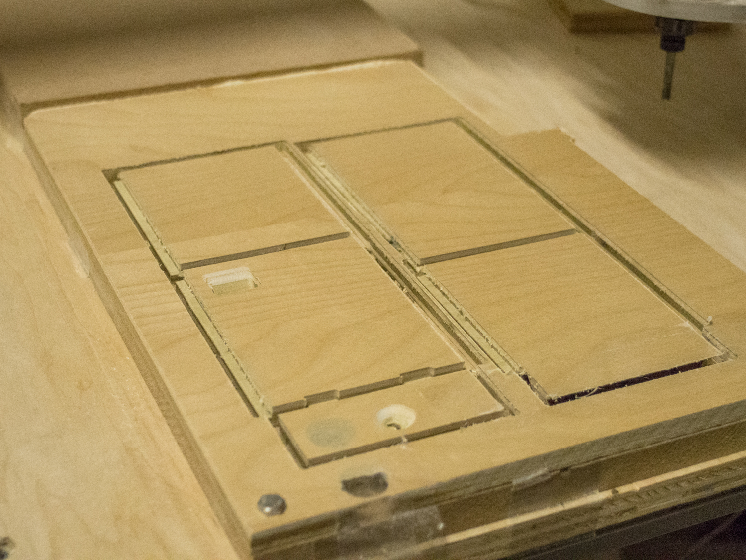 A prototype box was machined out of wood, the final product is white Delrin